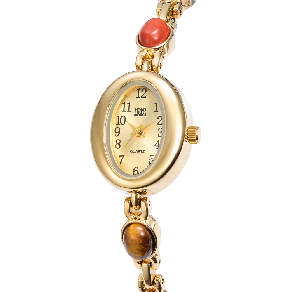 Gold oval faced wristwatch with varied gemstones in the band against a white background