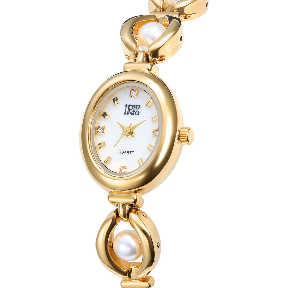 Gold wristwatch with pearl accents on a white background. Crystals in oval watch face at 12, 3, 6 and 9 markers.