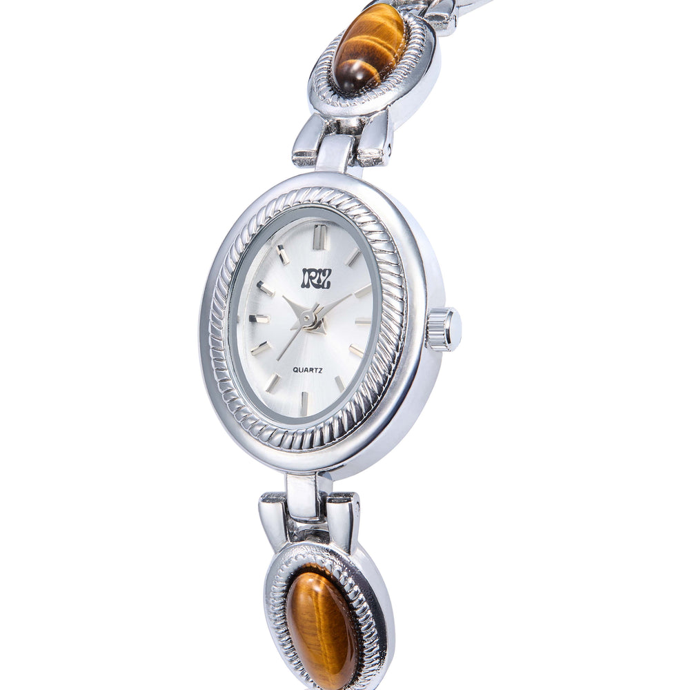 Silver oval-faced watch with tiger's eye stones in the band, set against  a white background