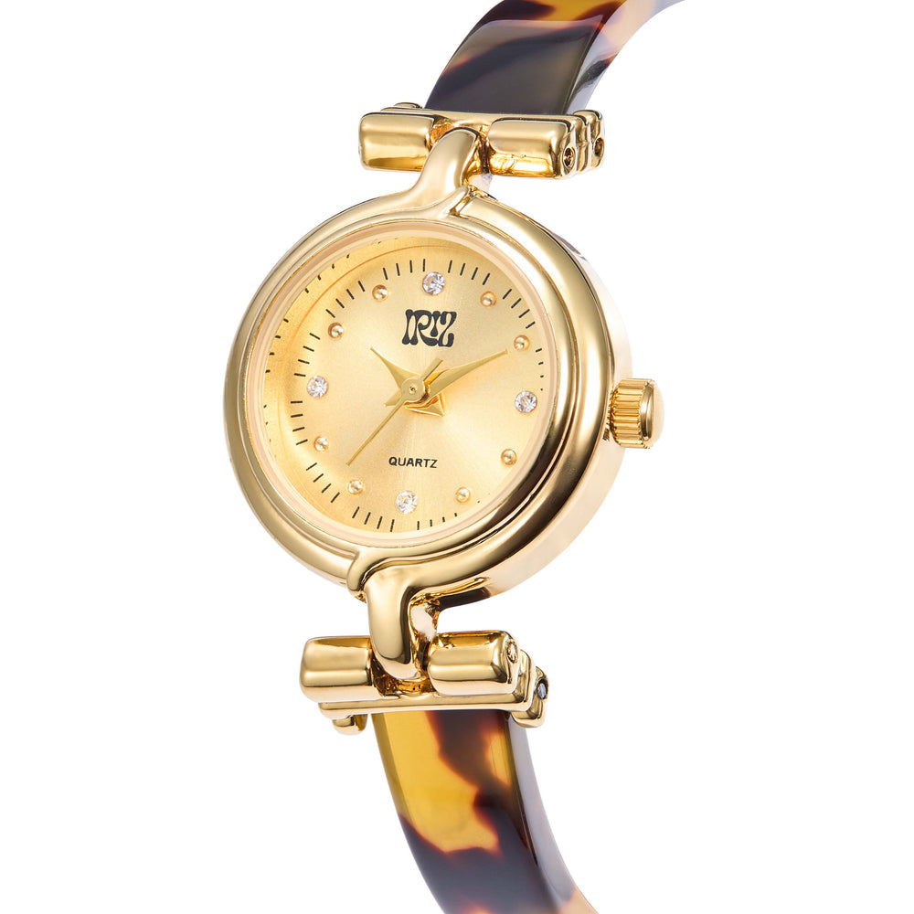 Gold watch with round face and crystal time markers, with tortoiseshell strap against white background